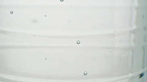 Bottle of table water, close shot. Bubbles of mineral water, abstract background Stock Footage 125840501