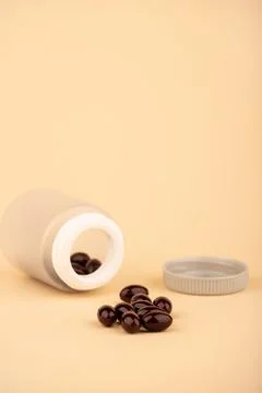 A bottle of tablets or capsules with krill oil is a dietary supplement rich i Stock Photos