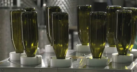 Bottle wash process on conveyor line. Conveyor with moving bottles made of green Stock Footage 249095314