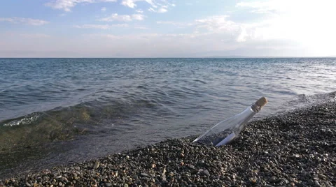 Bottle washed up by waves with a letter in it Stock Footage 68001054