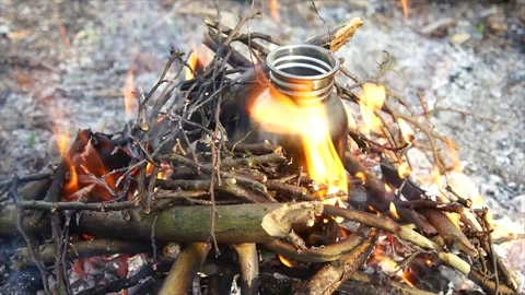 Bottle of Water Boiling over Campfire. Camping in Forest Stock Footage 109680200