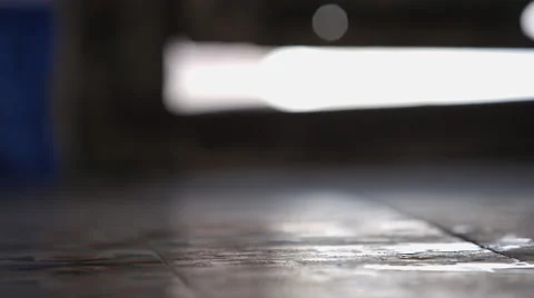 Bottle of water is falling down and the water is flowing out to the floor Stock Footage 65379099