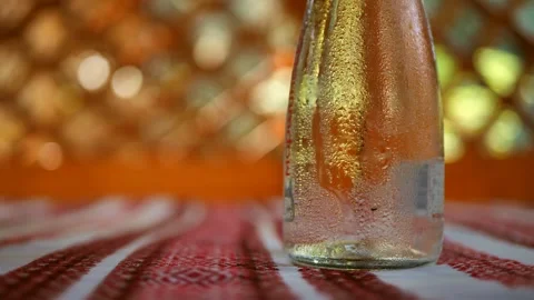 The bottle of water is removed from the table. Condensation on a bottle of table Stock Footage 247670174