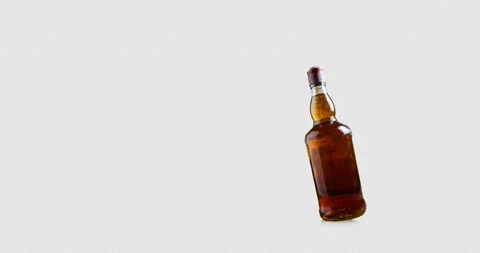 A bottle of whiskey falls Stock Footage 226434197