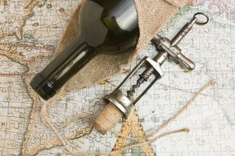 Bottle of wine and a corkscrew Stock Photos