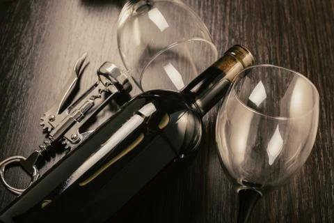 Bottle of wine and corkscrew Stock Photos