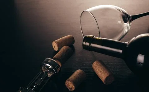 Bottle of wine and corkscrew Stock Photos