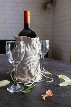 A bottle of wine and two empty glasses on the table Stock Photos