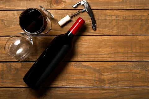 Bottle of wine corkscrew and corkscrew on wooden background. Top view with co Stock Photos