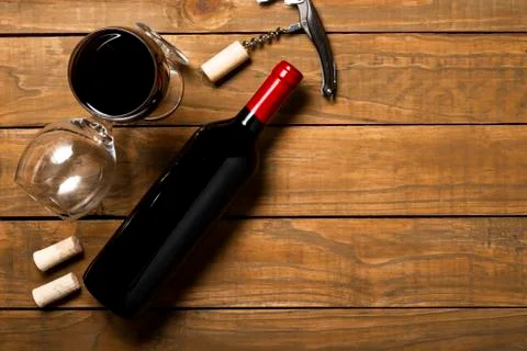 Bottle of wine corkscrew and corkscrew on wooden background. Top view with co Stock Photos
