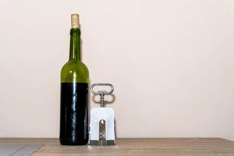 Bottle of wine with corkscrew Foto stock