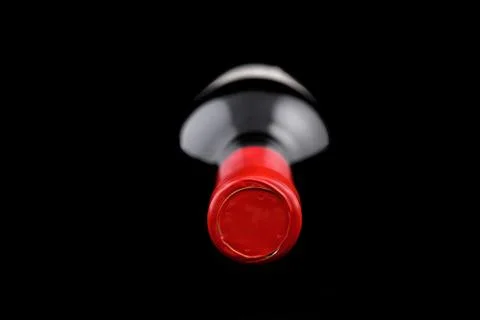 Bottle of wine lying down on a dark background Stock Photos