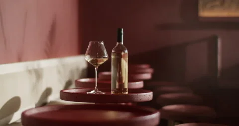 Bottle of wine placed on round table with wineglass Stock Footage 239167179