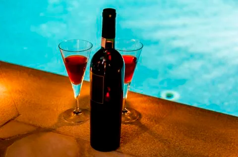 Bottle of wine at poolside Stock Photos
