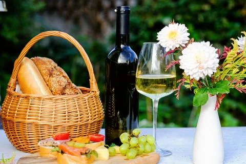 Bottle of wine on a table, summer outdoors. Picnic concept. Stock Photos