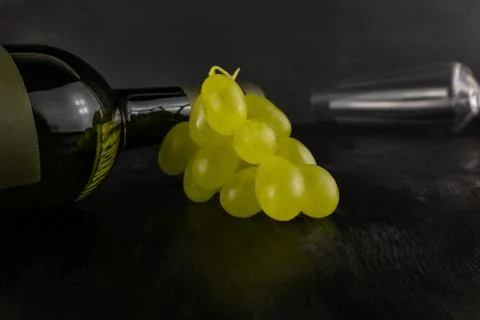 A bottle of wine white grapes and a glass Stock Photos