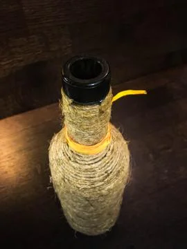 A bottle wrapped in string with orange stripe Stock Photos