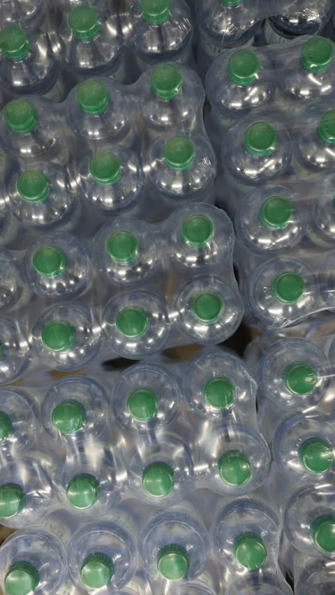 Bottled drinking water packed in plastic wrap for bulk retail storage Video stock 345977963