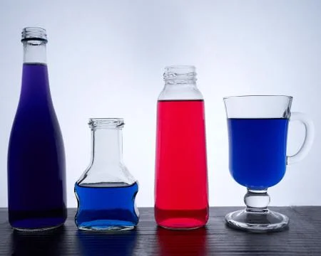 Bottled on a light background with blue and red liquid Stock Photos