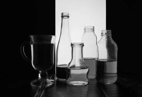 Bottled on a light background with liquid black and white silhouette photo Stock Photos