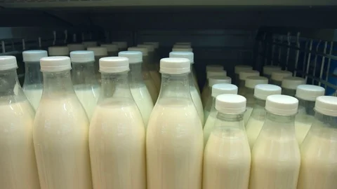 Bottled milk on the shelf in the store. Video stock 83826976