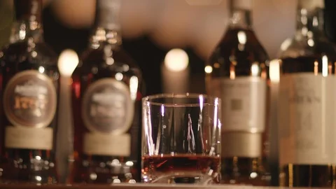 Bottles of Alcohol on Table Rack Focus 스톡 동영상 102722558