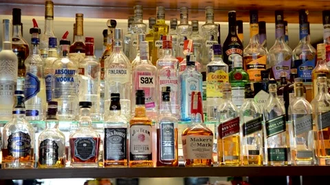 Bottles of alcoholic beverages in a row displayed in restaurant. Alcoholic Stock Footage 152859136