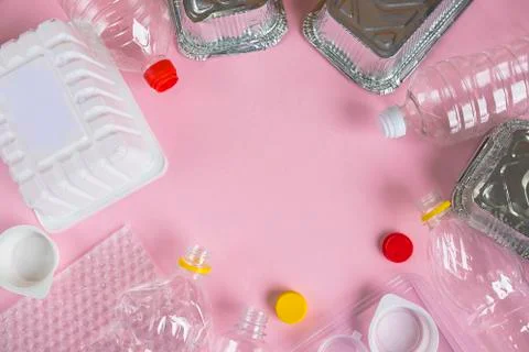 Bottles and containers flat lay on pink background with copy space Stock Photos