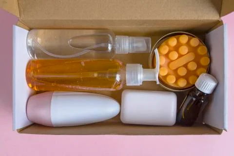 Bottles and containers flat lay on pink background with copy space Stock Photos