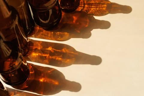Bottles Casting Golden Light Patterns Stock Photos