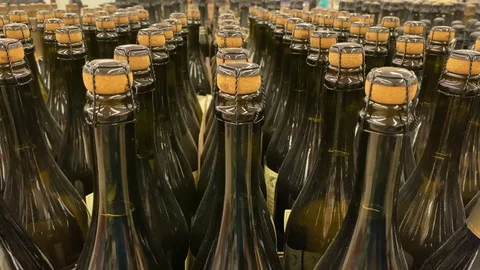 Bottles of champagne or wine stand in a supermarket Stock-Footage 120323980