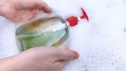 Bottles of detergents float in the foam. The concept of the dangers of household Stock-Footage 146720278
