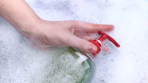Bottles of detergents float in the foam. The concept of the dangers of household Stock-Footage 146720322