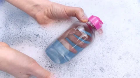 Bottles of detergents float in the foam. The concept of the dangers of household Stock-Footage 146720366