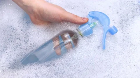 Bottles of detergents float in the foam. The concept of the dangers of household Stock Footage 146720385
