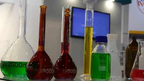 Bottles with different-flowered liquids green 動画素材 120141220