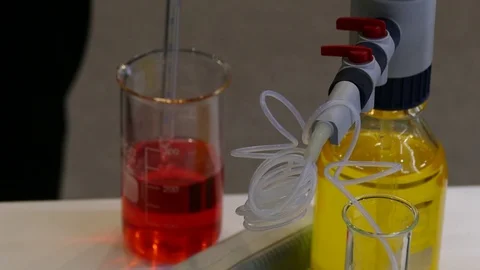 Bottles with different-flowered liquids green 動画素材 120141316