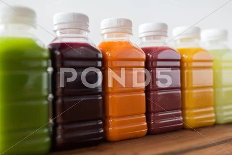 Bottles with different fruit or vegetable juices Stock Photos