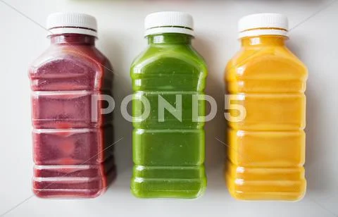 Bottles with different fruit or vegetable juices Stock Photos