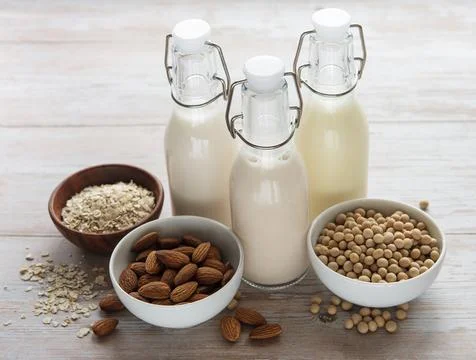 Bottles with different vegetable milk Stock Photos