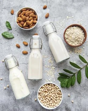 Bottles with different vegetable milk Stock Photos