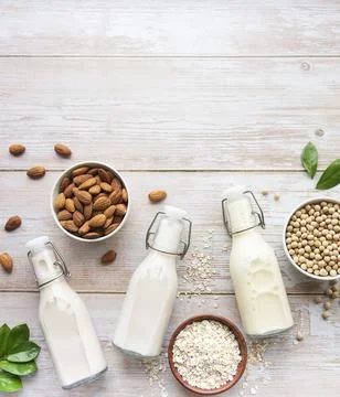 Bottles with different vegetable milk Foto stock