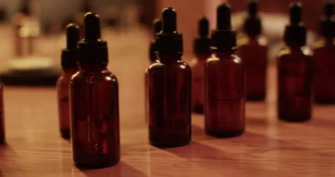 Bottles of essential oils in dark workshop Stock Footage 260982323