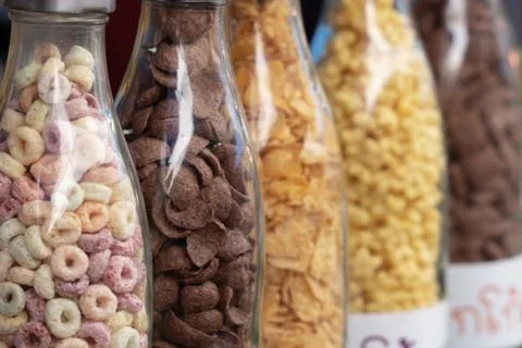 Bottles filled with different types of cereal. Stock Photos