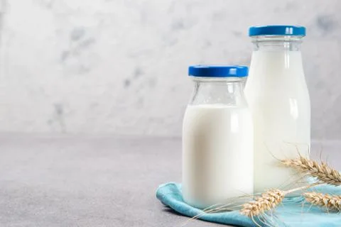 Bottles of fresh milk on a table Stock Photos