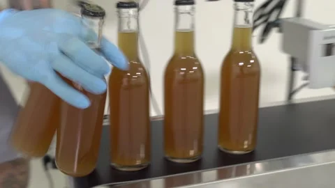 Bottles going through the date printing machine Stock Footage 132052394