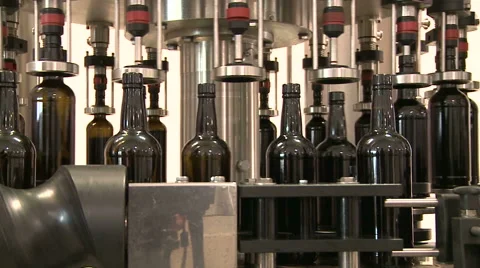 Bottles on a industrial machine. Bottling machine. Video stock 63225978
