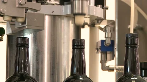 Bottles on a industrial machine. Bottling machine. Stock Footage 63238780