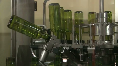 Bottles on a industrial machine. Bottling machine. Stock Footage 63370922