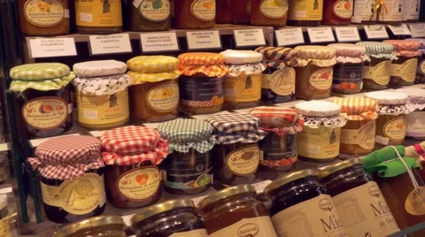 Bottles of jam in the market La Boqueria in Barcelona Stock Footage